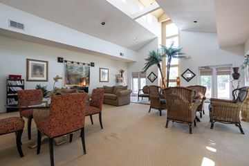 Overland Park apartment for rent - A living room with a variety of chairs and a dining table.